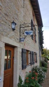 a building with a sign on the side of it at B&B Des Histoires d'Anges - Côté Jardin in Tournus