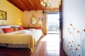 a bedroom with a bed and a view of the ocean at Villa Katerina-Despina in Argoulidhés