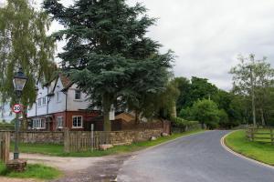 a house with a tree on the side of a road at Mill Croft Bed and Breakfast in Goathland