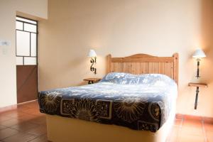 En eller flere senge i et værelse på Hotel Rincón Poblano