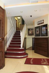 a staircase in a home with red and white carpet at Kings Cross Inn Hotel in London