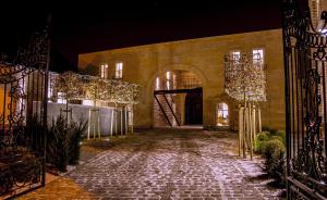 a stone walkway leading into a building at night at B&B 4 Seasons in Riemst