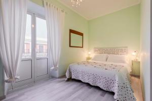 a bedroom with a bed and a large window at A Roman Tale B&B in Rome