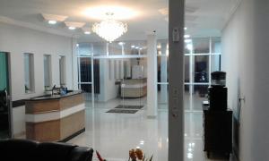 a lobby with a reception desk in a building at Rocha's Hotel in Guarapuava