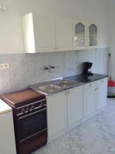 a kitchen with a sink and a stove at Rozs Ház in Zalakaros