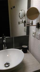 a bathroom with a white sink and a mirror at T1 cabine de Letious in Luz-Saint-Sauveur +11 photos
