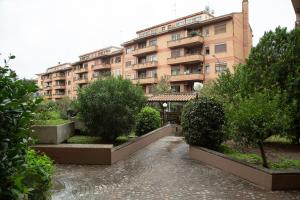 a large apartment building with a garden in front of it at Eur Home in Rome