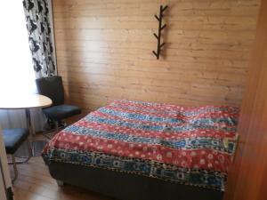 a bedroom with a bed with a red quilt on it at Bergsee in Schluchsee