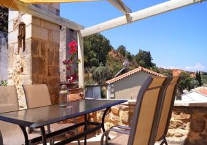 a table and chairs on a patio with a view at Zamaros Traditional Villa in Maroulás