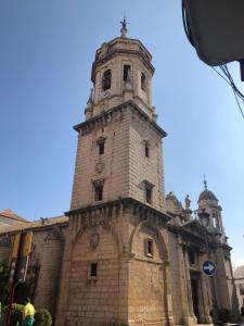 un viejo edificio de ladrillo con una torre de reloj. en Peso de la Harina - piso completo, en Jaén