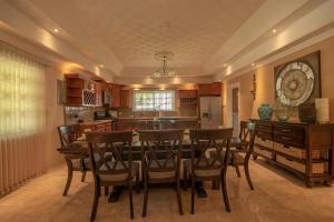 a kitchen with a dining room table and chairs at Tropical Escape Villa in Ocho Rios