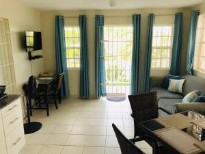 a living room with a couch and a table at Turtle Ridge Apartments in Saint James
