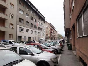 a row of cars parked on a city street at My Miracle Apartment in Zagreb