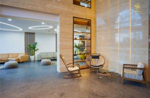 a lobby with chairs and tables in a building at Mandala Hotel & Spa Bac Ninh in Bắc Ninh