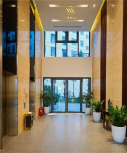 an entrance to a lobby with potted plants at Mandala Hotel & Spa Bac Ninh in Bắc Ninh