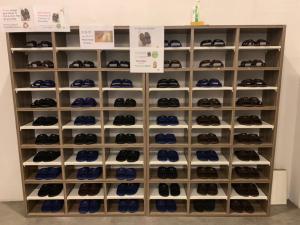 a display case filled with lots of shoes at Norn Yaowarat Hotel in Bangkok