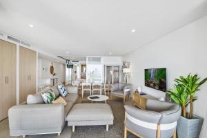 a living room with a couch and chairs at Breeze Mooloolaba, Ascend Hotel Collection in Mooloolaba