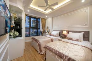 
a bedroom with a large bed and a large window at Royal Holiday Hanoi Hotel in Hanoi
