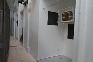 an empty hallway with a white wall and a heater at Red Apartelle in Talisay