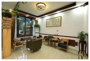 a restaurant with tables and chairs in a room at Xian Yan Inn in Yueqing