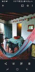 a room with a bed, a chair, and a window at Las Cabañas Castillos del Lago in Guatapé