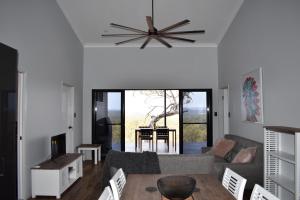 a living room with a couch and a table at Ironbark House in Dimbulah