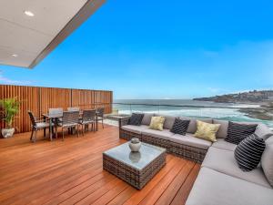 a living room with a couch and a table at Tamarama Apartments in Sydney