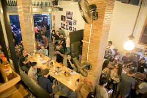 a group of people sitting at tables in a restaurant at The Big Easy Phnom Penh in Phnom Penh