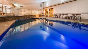 a swimming pool with chairs in a building at Best Western Plus of Birch Run/Frankenmuth in Birch Run