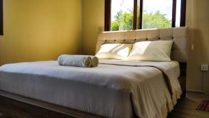 una camera da letto con un grande letto e un asciugamano di Eden Blue a Thulusdhoo