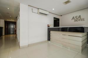 a hotel lobby with aania hotel sign on the wall at RedDoorz Plus near Galaxy Bekasi in Bekasi