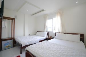 En eller flere senge i et værelse på Thanh Sang Guesthouse