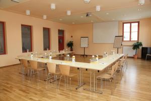 una grande sala conferenze con un grande tavolo e sedie di JUFA Hotel Hochrindl a Hochrindl