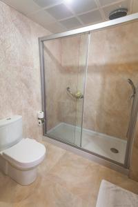 a bathroom with a shower and a white toilet at Hotel Aqua in Marmaris
