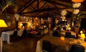 a restaurant with tables and chairs in a room at Pousada Paraiso in Itaipava