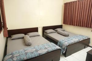 Tempat tidur dalam kamar di Villa Cemara