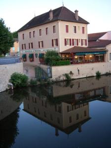 
a large building with a view of the water at Hostellerie d'Héloïse in Cluny
