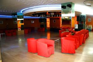a group of red chairs in a room at AR Roca Esmeralda & SPA Hotel in Calpe