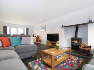 a living room with a couch and a fireplace at Myles View in Penzance