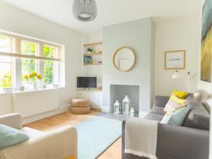 a living room with a couch and a tv at Teviot Cottage in Corbridge