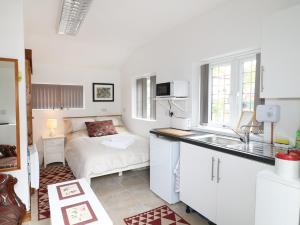 a kitchen with a sink and a bed in a room at Kissingate in Mansfield