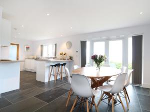 a kitchen and dining room with a table and chairs at Myles View in Penzance