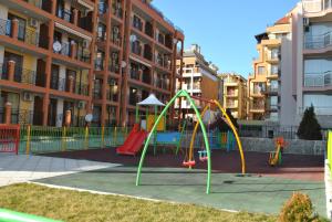 a playground in front of a apartment building at Antorini Apartments in Sveti Vlas