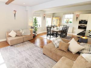 a living room with a couch and a dining room at Castle Hill in Bakewell