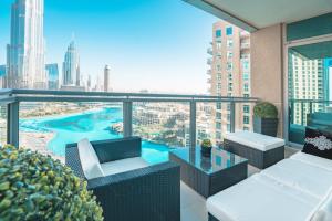 a balcony with furniture and a view of a city at Elite Royal Apartment - Burj Residences T5 | Diamond in Dubai