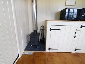 a room with a wood stove in a room at Moor Skies in Keighley