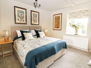 a bedroom with a bed and a window and two lamps at Castle Hill in Bakewell