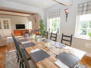 a dining room with a long wooden table and chairs at Castle Hill in Bakewell