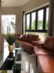 - un salon avec un canapé en cuir et une table en verre dans l'établissement HOÀNG SA HOTEL, à Cam Ranh