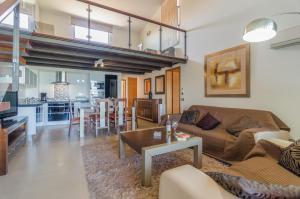 a living room with a couch and a table at Mar da Luz in Luz